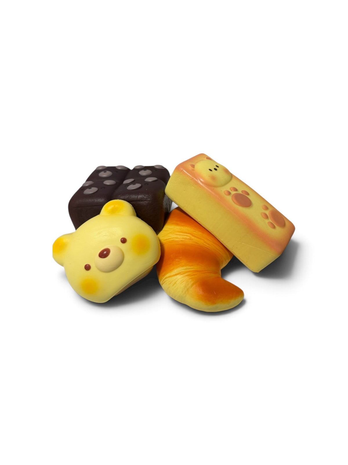My Store assorted miniature food squishy toys including a bear bun, croissant, and chocolate block in soft foam.